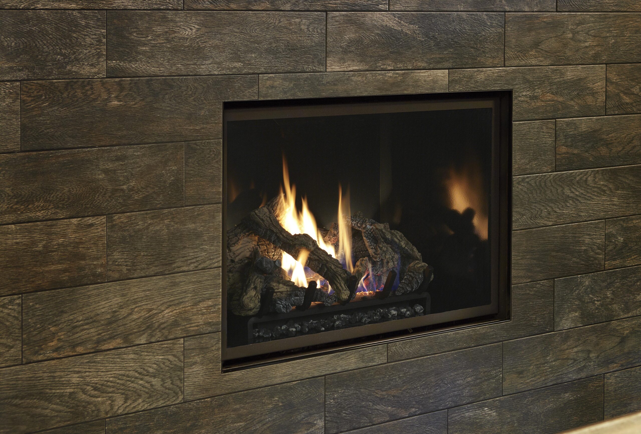 Fireplace Xtrordinair 864 Clean Face Gas Fireplace with Adjustable Tile Trim Kit and Black Enamel Fireback set in wood grain tile